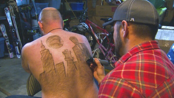 An artist shaving a skyline out of back hair